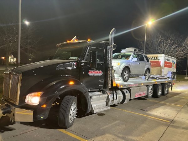 car and U-Haul on tow truck