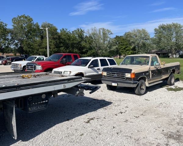 Line of vehicles in gravel parking lot