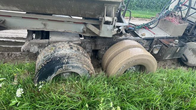 Wheels of truck in mud and grass