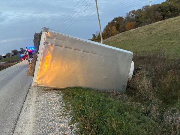 Truck on side with nose in ditch
