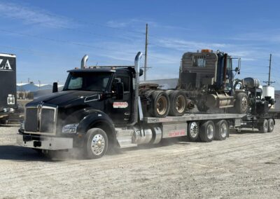 Semi tractor on flatbed tow truck