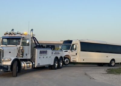 Bus being towed by heavy duty tow truck