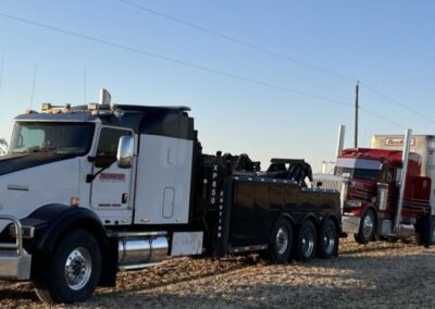 Livestock truck being tow by heavy duty tow truck
