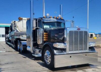 Large truck carring a large piece of equipment