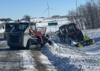 Skid steer used to recovery truck and equipment off road in the snow