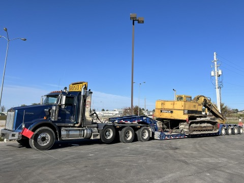 Yellow excavator on a long trailer